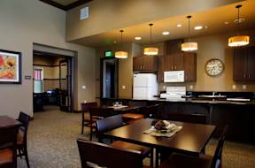 a dining room and kitchen with a table and chairs