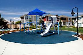 a playground with a slide in front of houses