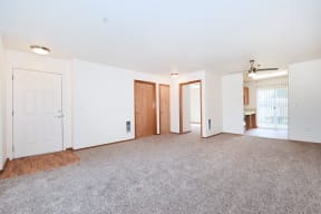 an empty living room with white walls and a carpeted floor
