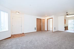 an empty living room with white walls and a carpeted floor