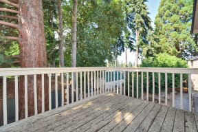 large deck overlooking the pool and trees in the backyard