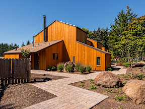 a wooden house with a courtyard and trees