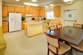 a kitchen with a table and chairs