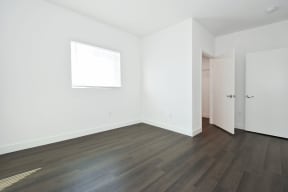 a room with white walls and chairs and wooden floors