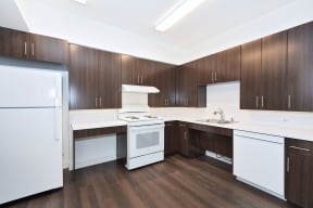 a kitchen with white appliances and wooden cabinets