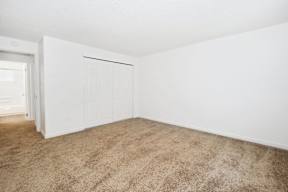 an empty living room with white walls and a white door
