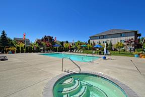 A large outdoor swimming pool with a slide.