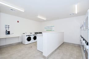 a laundry room with two washes and a dryer