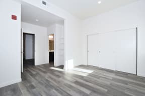 a renovated living room with white walls and wood floors