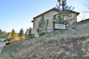 a house on a hill with a sign in front of it