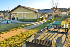 a picnic table in front of a green building