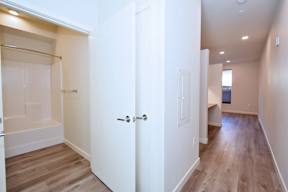 A white door is open to a hallway.