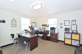 an office with a desk and a computer and a filing cabinet