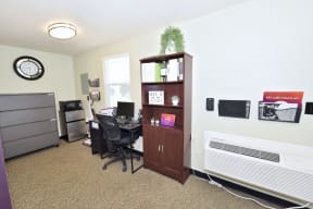 an office with a desk and a cabinet with a computer