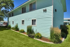 a blue house with a garden in front of it