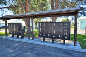 three lockers on a bench in a park