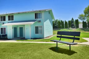 a bench in front of a blue house