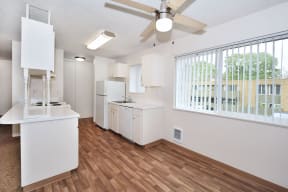 an open kitchen and living room with a large window