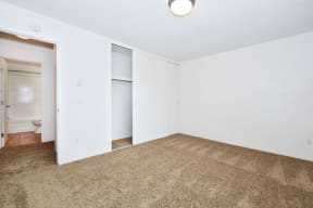 an empty living room with carpet and white walls