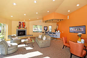 A living room with orange walls and furniture.