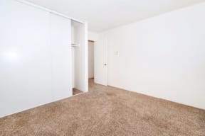 an empty room with a carpeted floor and white walls