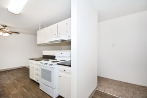a kitchen with white appliances and white cabinets