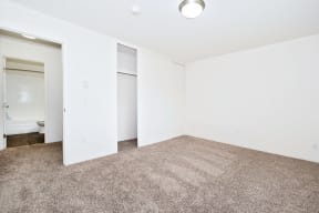 an empty living room with white walls and carpet