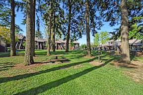 A park with a grassy area and trees.