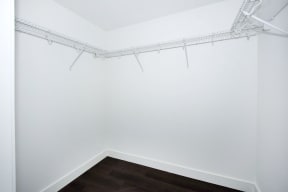 an empty room with white walls and a wood floor