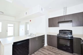 a kitchen with white countertops and dark wood cabinets