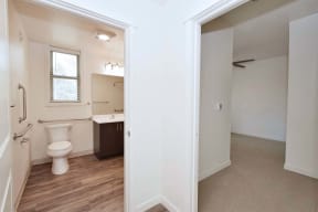 a bathroom with a toilet and a sink and a mirror