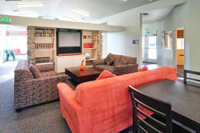 a living room with couches a table and a television