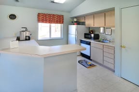 a kitchen with a white counter top and a white stove top oven