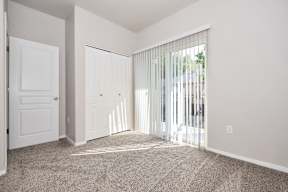 A room with a carpeted floor and white walls.