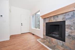 a living room with a fireplace and a window