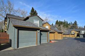 a row of garage doors on the side of a house