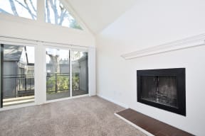 Timberwood Beaverton:  a living room with a fireplace and a balcony