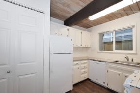 Menlo Manor: kitchen with white cabinets and white appliances