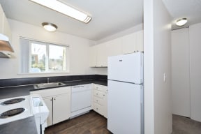 Menlo Manor: kitchen with white appliances and white cabinets