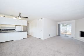 Menlo Manor: living room and kitchen with a sliding glass door to a patio