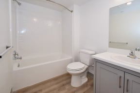 a bathroom with a bathtub toilet and sink in a 555 waverly unit