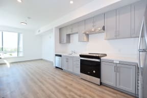 a kitchen with white cabinets and a black stove top oven