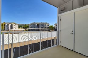 a balcony with a door and a view of a building