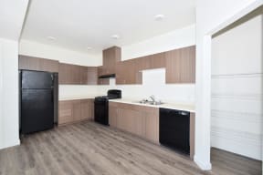 a kitchen with white countertops and black appliances