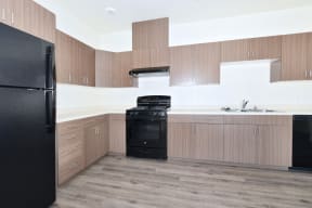a kitchen with wooden cabinets and black appliances