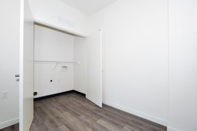 a bedroom with a medium hardwood floor and white walls