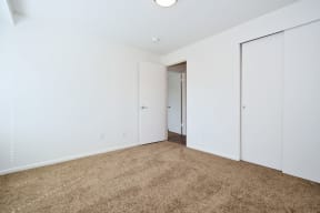 a bedroom with a carpeted floor and white walls