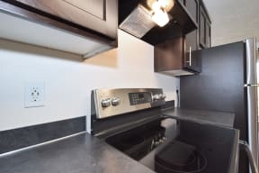a kitchen with a stove top oven next to a refrigerator