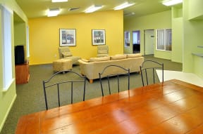 a lounge area with couches chairs and a table
