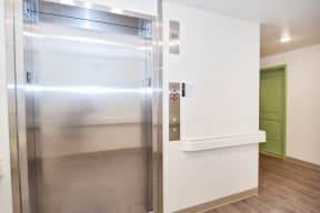 a large stainless steel refrigerator in a kitchen with a green door in the background